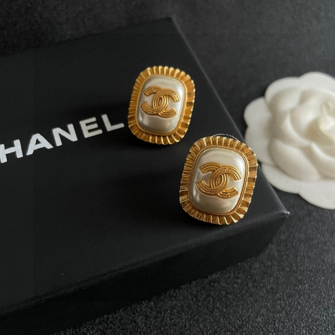 Martin Graham stud earrings in polished metal-tone – detail view