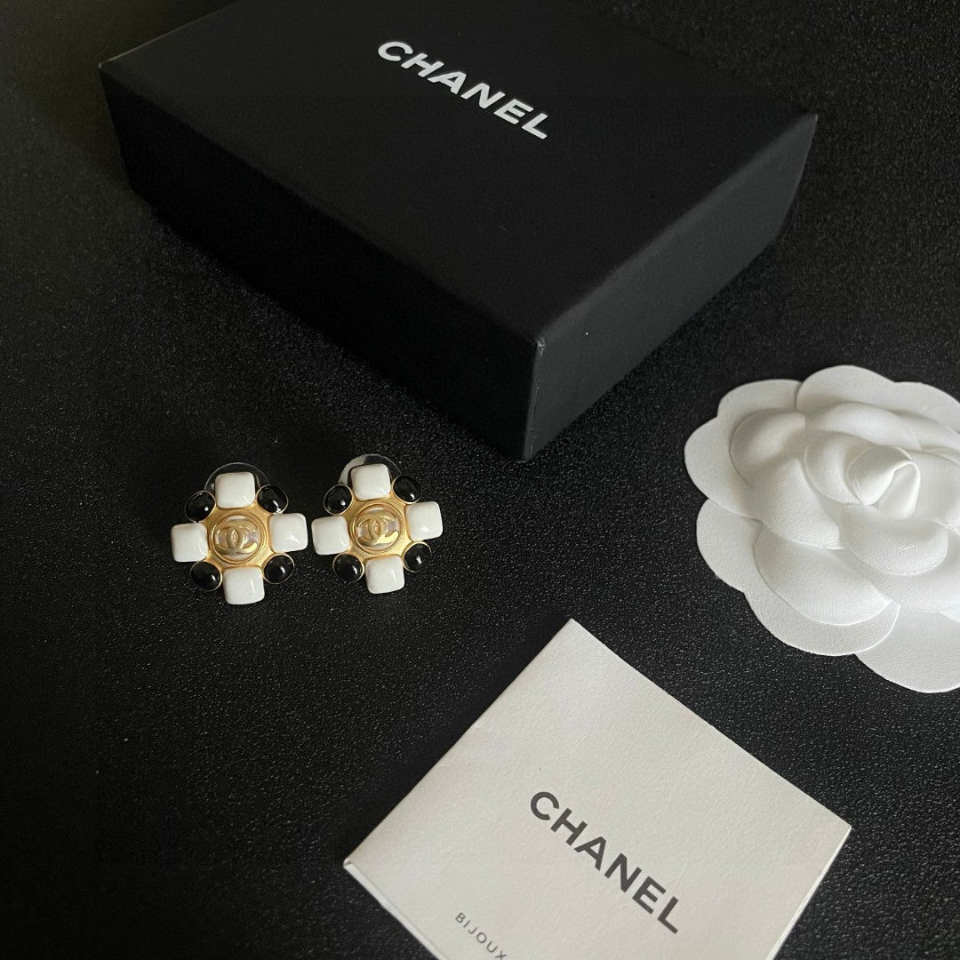 Martin Graham stud earrings in polished metal-tone – close-up detail