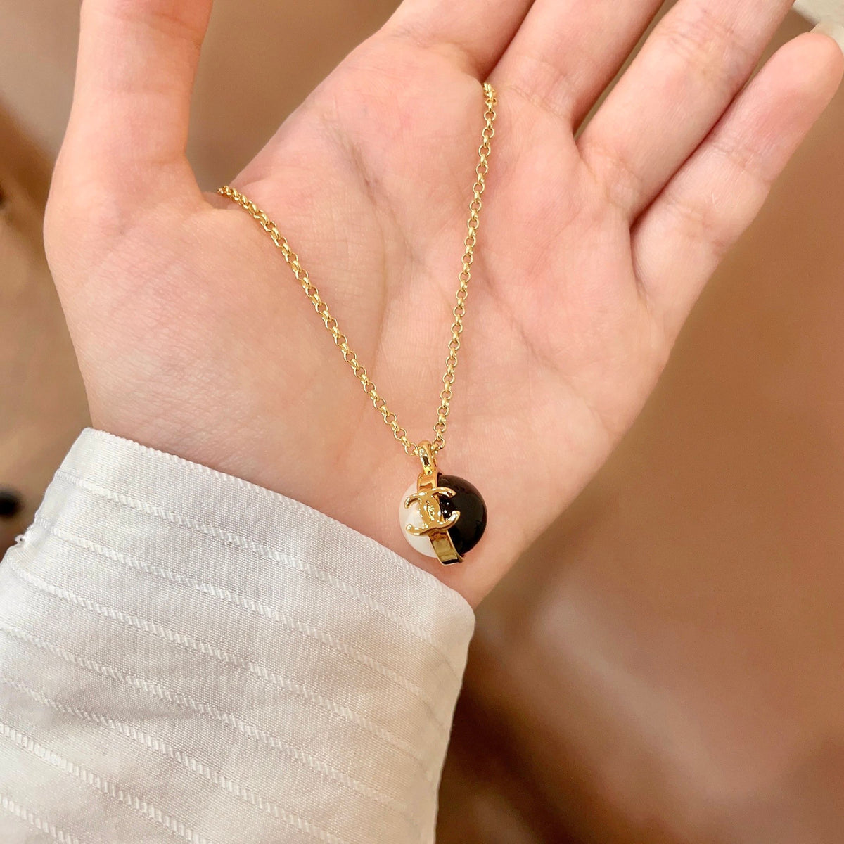Martin Graham pendant necklace in polished metal-tone – side detail