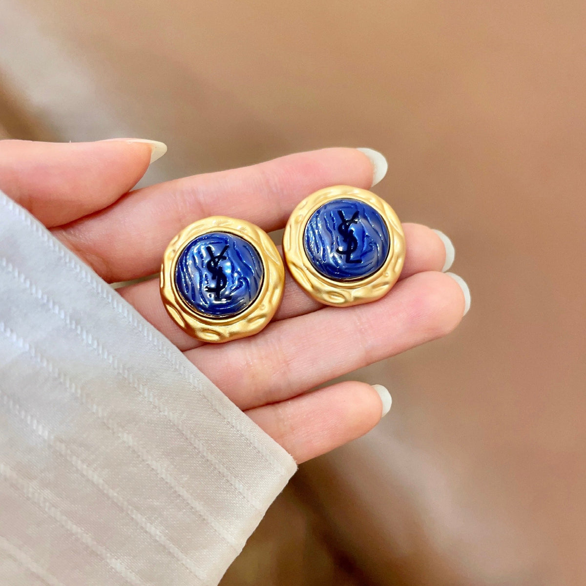 Martin Graham stud earrings in polished metal-tone – side detail