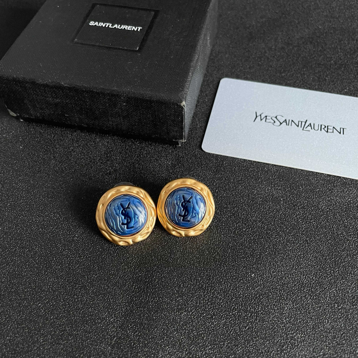 Martin Graham stud earrings in polished metal-tone – close-up detail