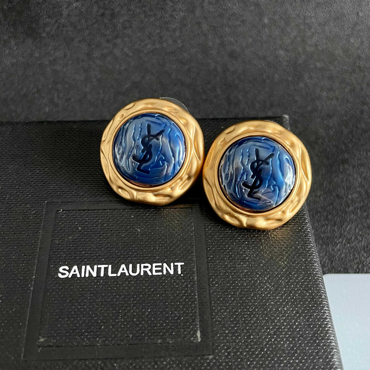 Martin Graham stud earrings in polished metal-tone – detail view