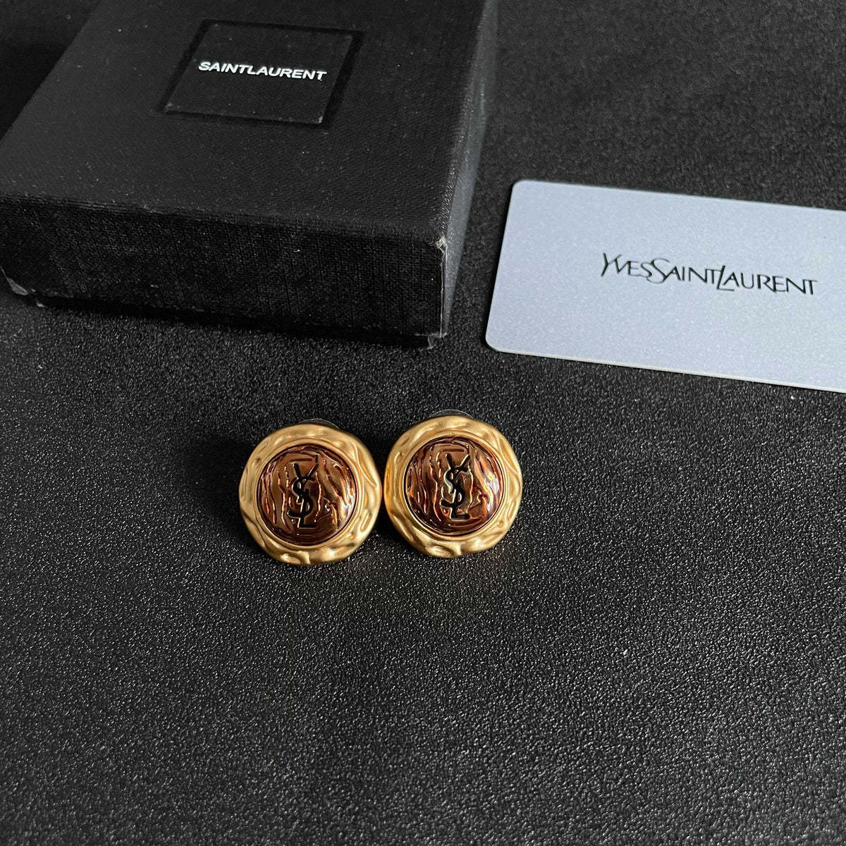 Martin Graham stud earrings in polished metal-tone – close-up detail