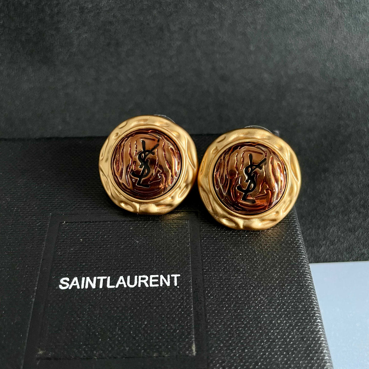 Martin Graham stud earrings in polished metal-tone – detail view