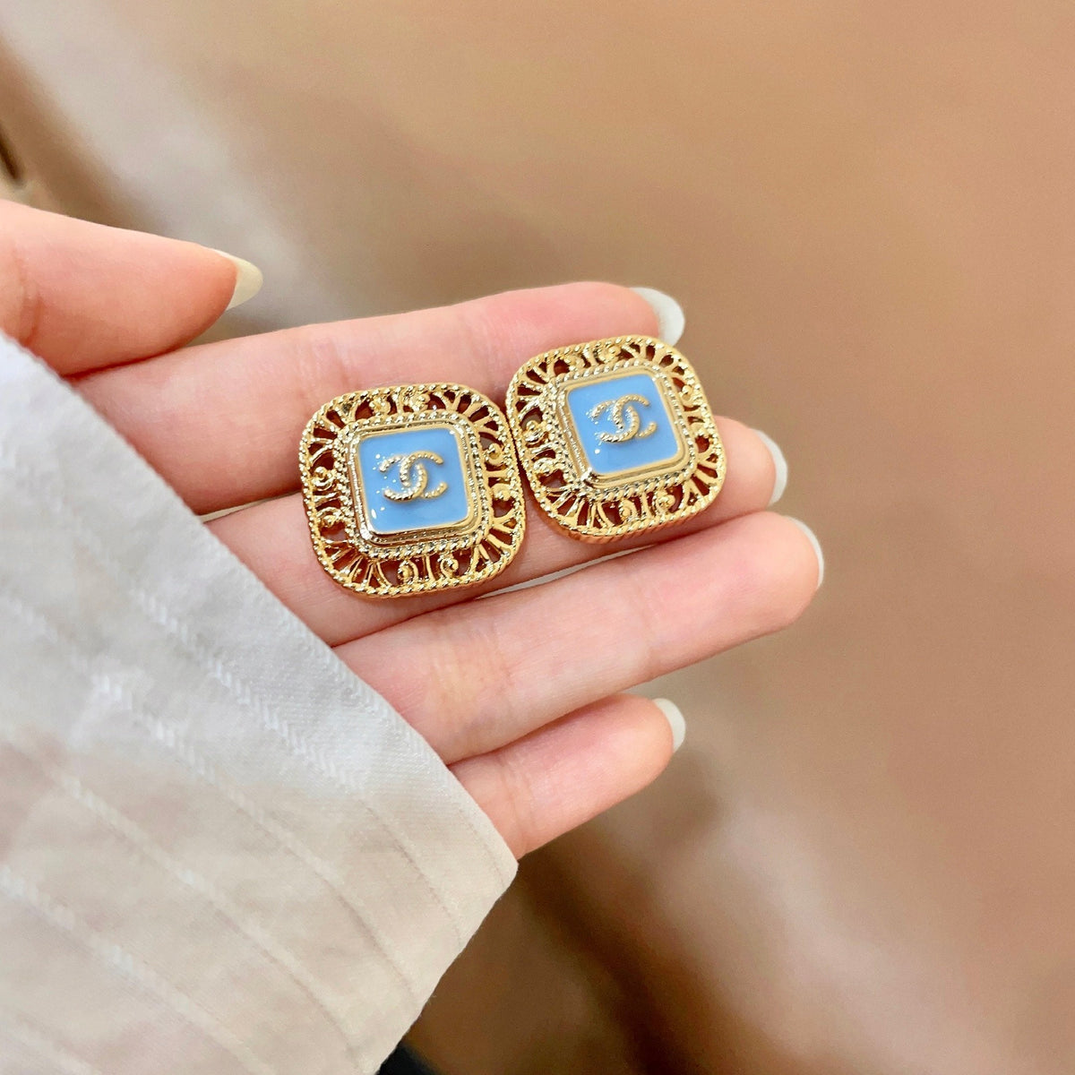 Martin Graham stud earrings in polished metal-tone – side detail