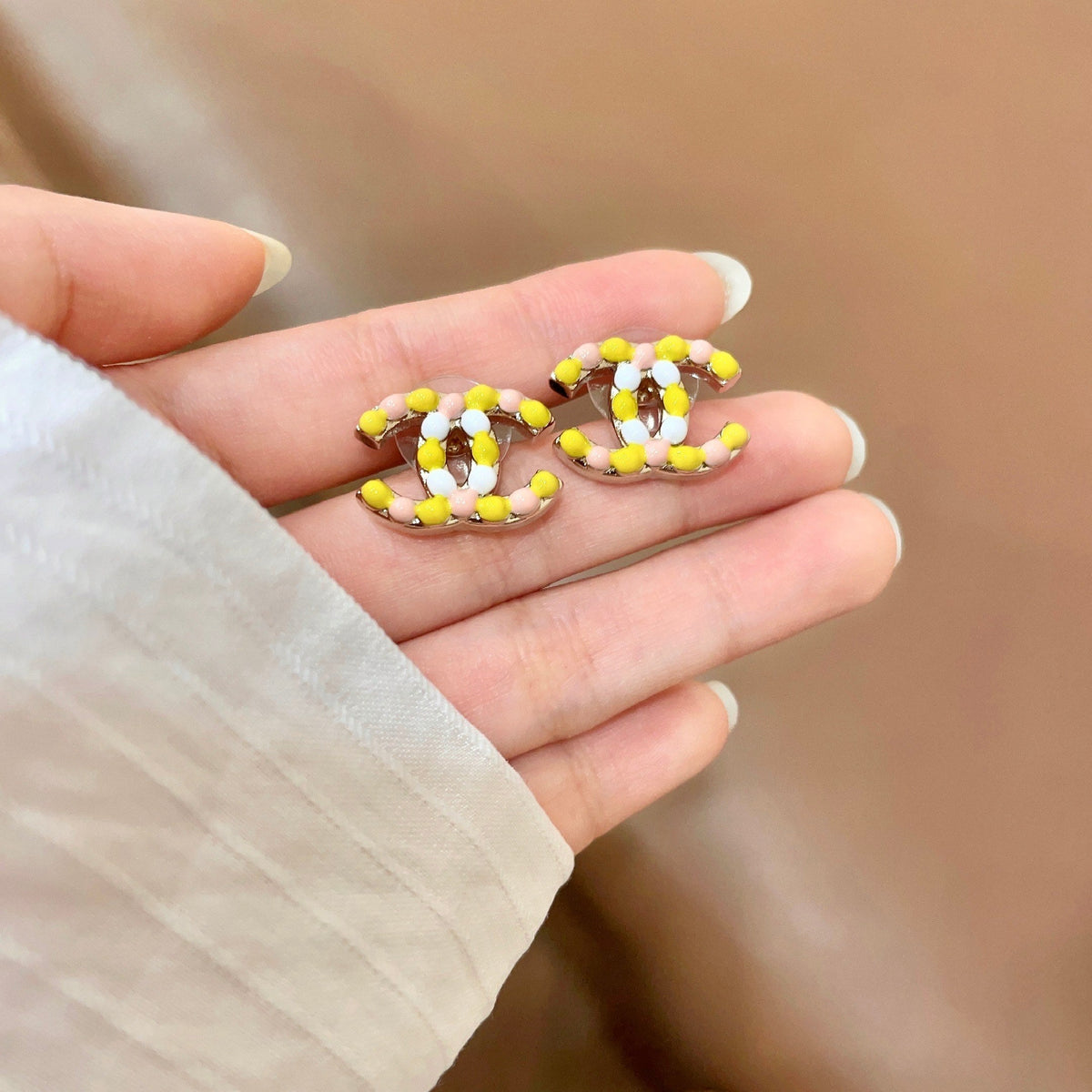 Martin Graham stud earrings in polished metal-tone – side detail