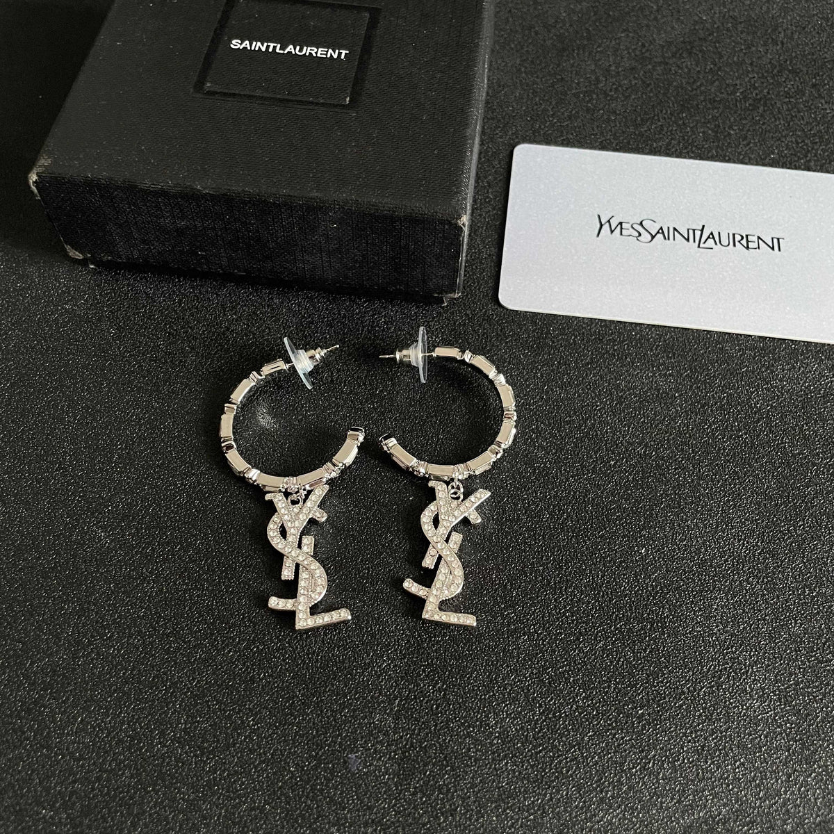 Martin Graham stud earrings in polished metal-tone – close-up detail