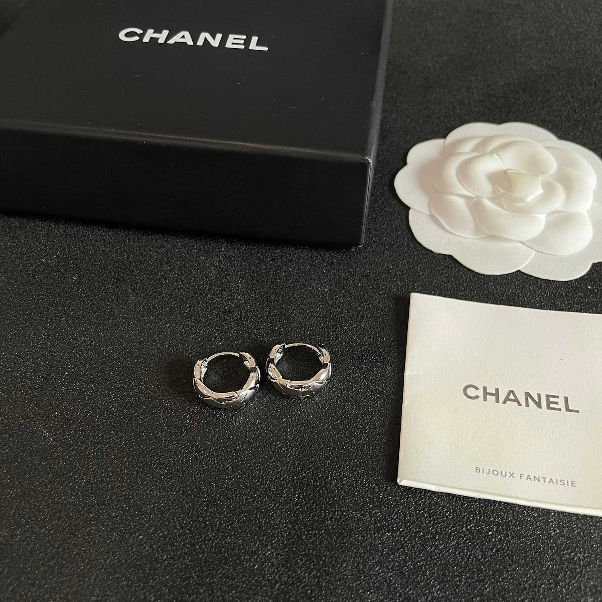 Martin Graham stud earrings in polished metal-tone – close-up detail