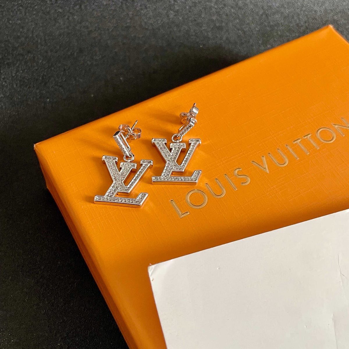 Martin Graham stud earrings in polished metal-tone – styled product view