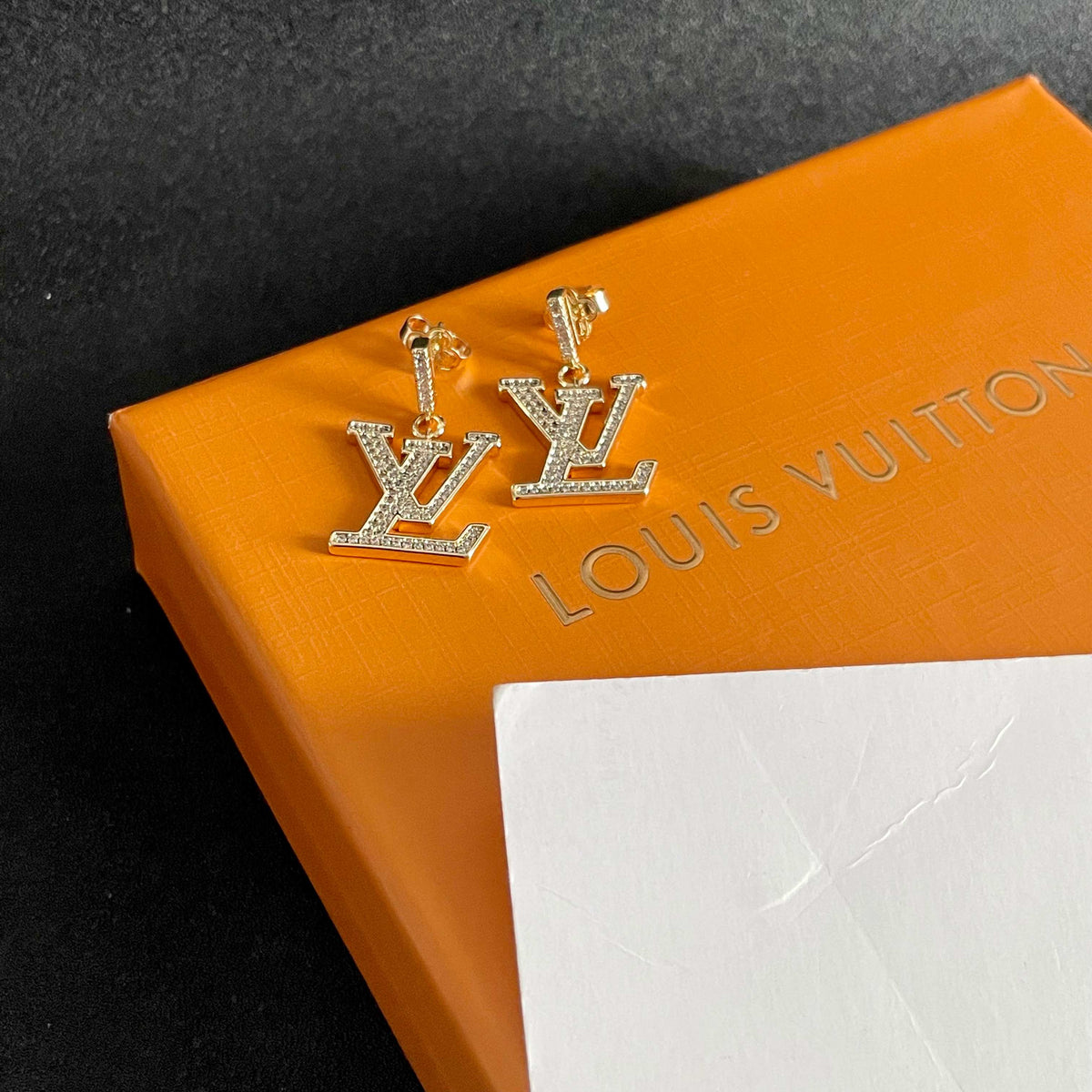 Martin Graham stud earrings in polished metal-tone – styled product view