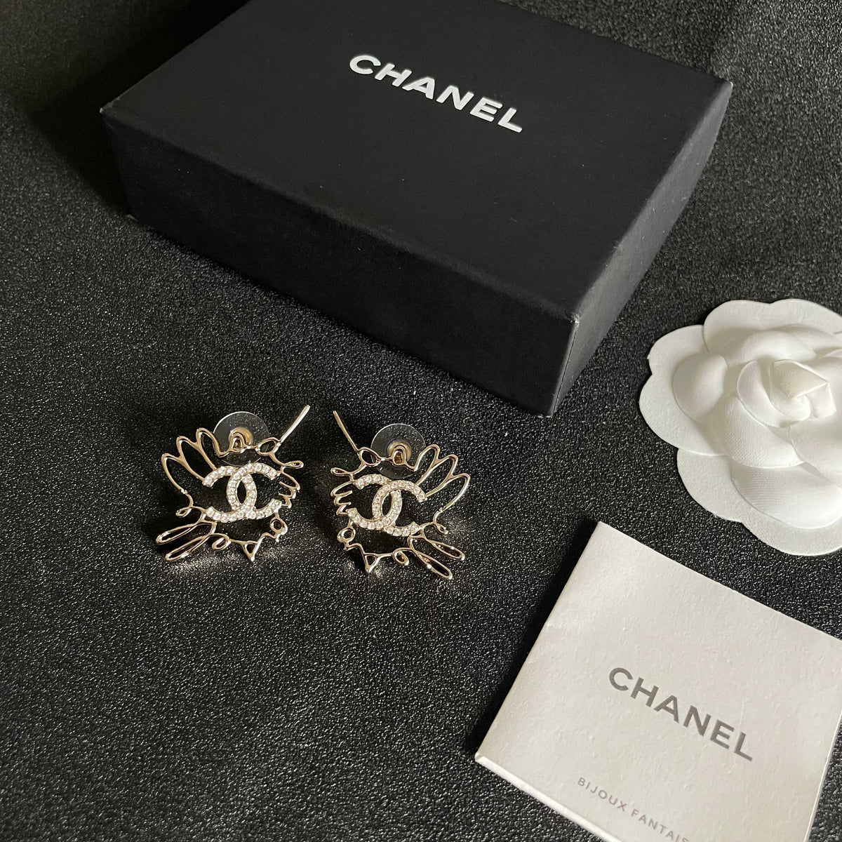 Martin Graham stud earrings in polished metal-tone – close-up detail