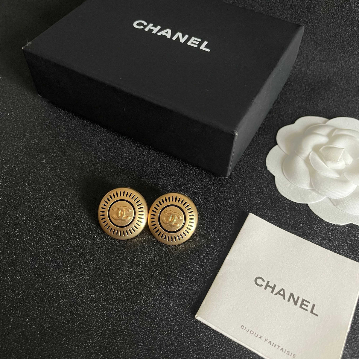 Martin Graham stud earrings in polished metal-tone – close-up detail