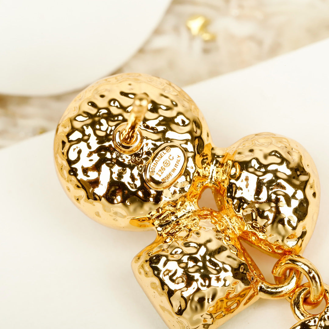 Martin Graham earrings in polished metal-tone – close-up detail