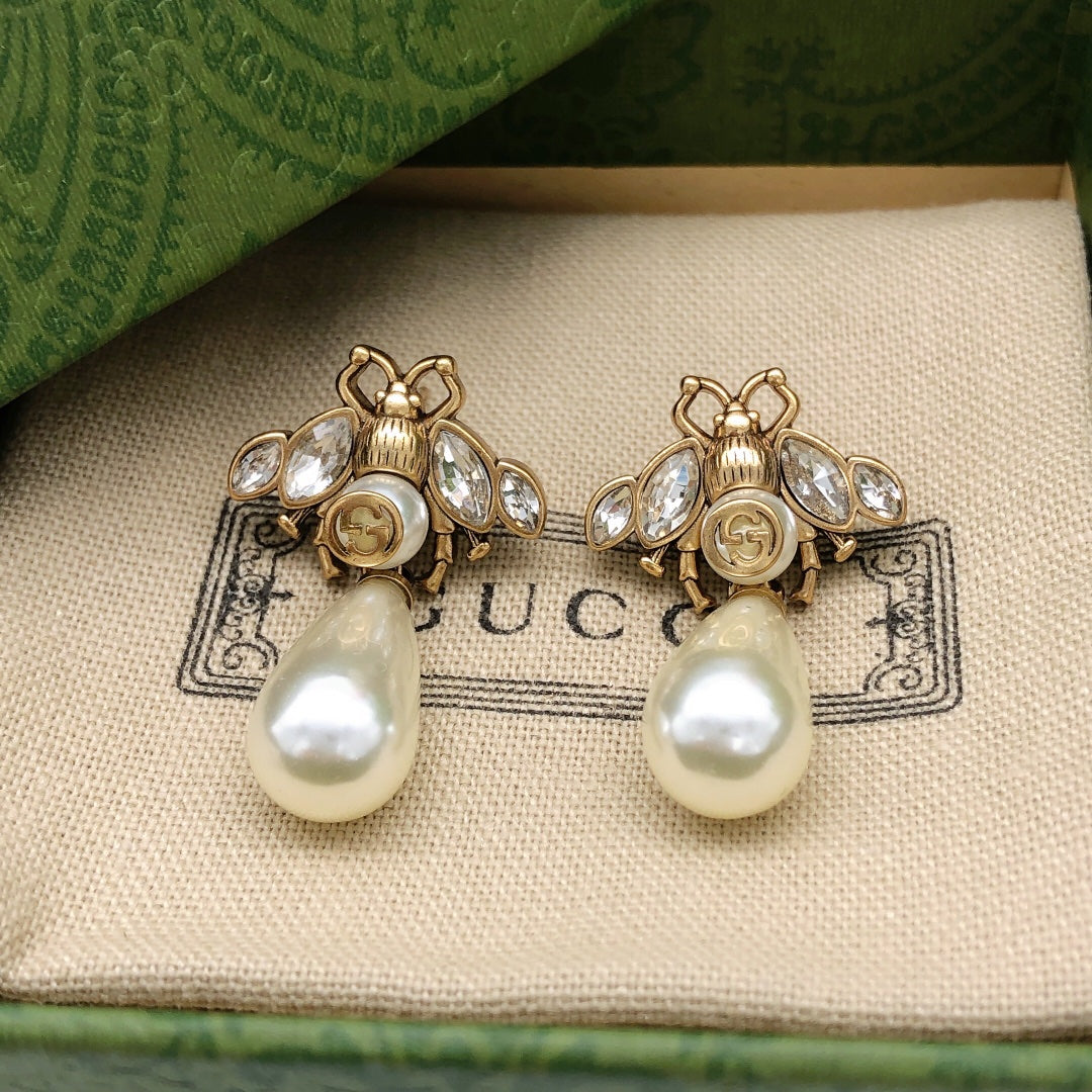Martin Graham stud earrings in polished metal-tone – close-up detail