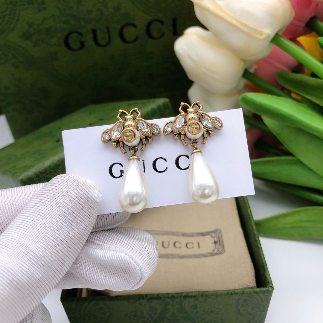 Martin Graham stud earrings in polished metal-tone – front product view