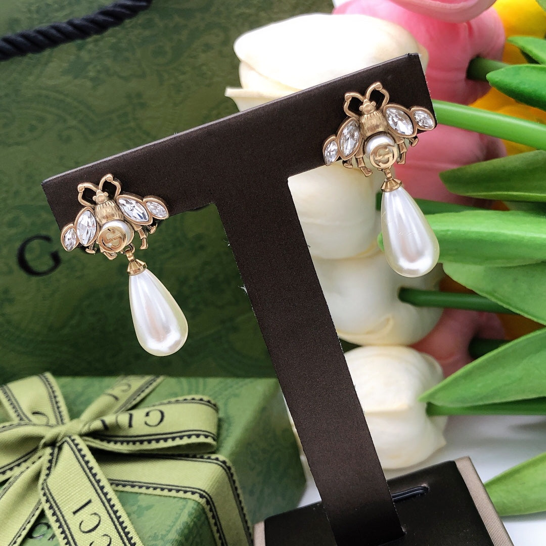 Martin Graham stud earrings in polished metal-tone – styled product view