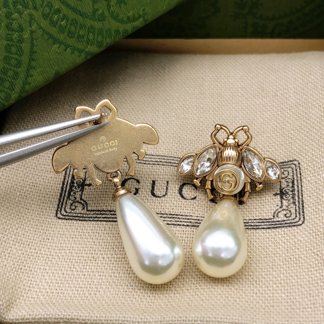 Martin Graham stud earrings in polished metal-tone – detail view