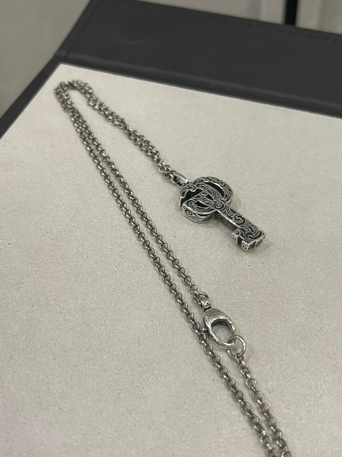 Martin Graham jewelry accessory in polished metal-tone – side detail