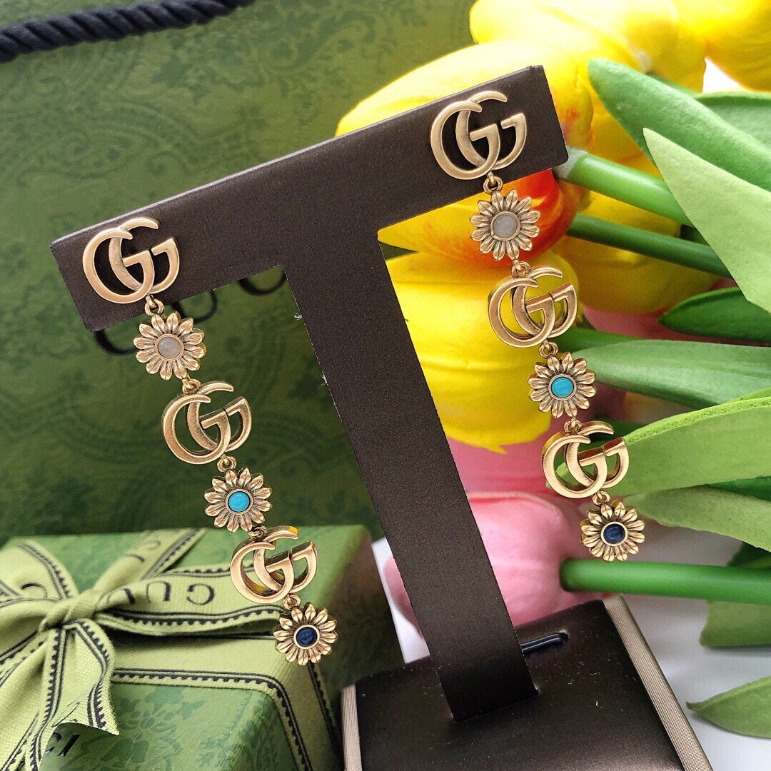 Martin Graham stud earrings in polished metal-tone – close-up detail