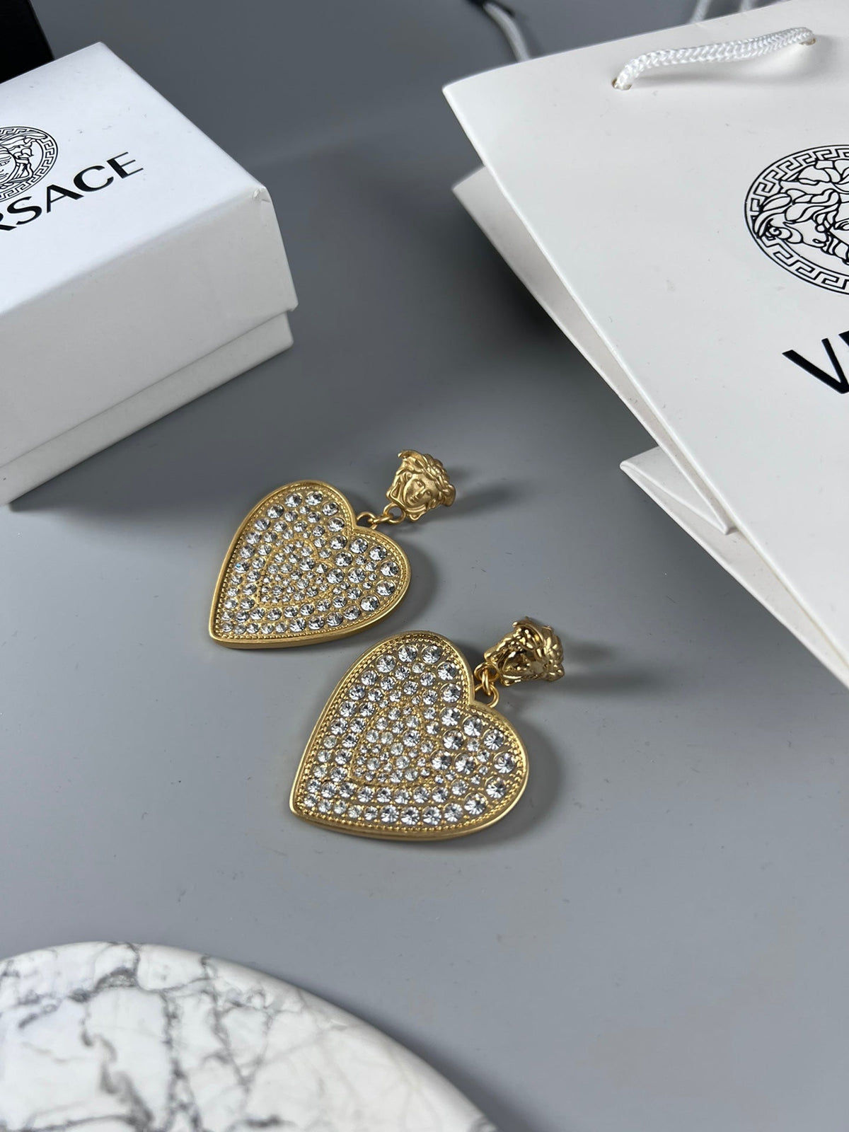 Martin Graham stud earrings in polished metal-tone – styled product view