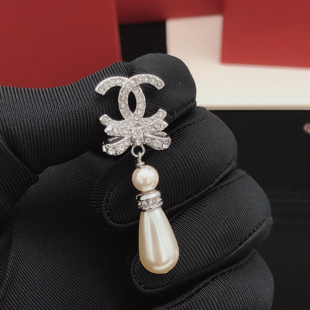 Martin Graham stud earrings in polished metal-tone – close-up detail