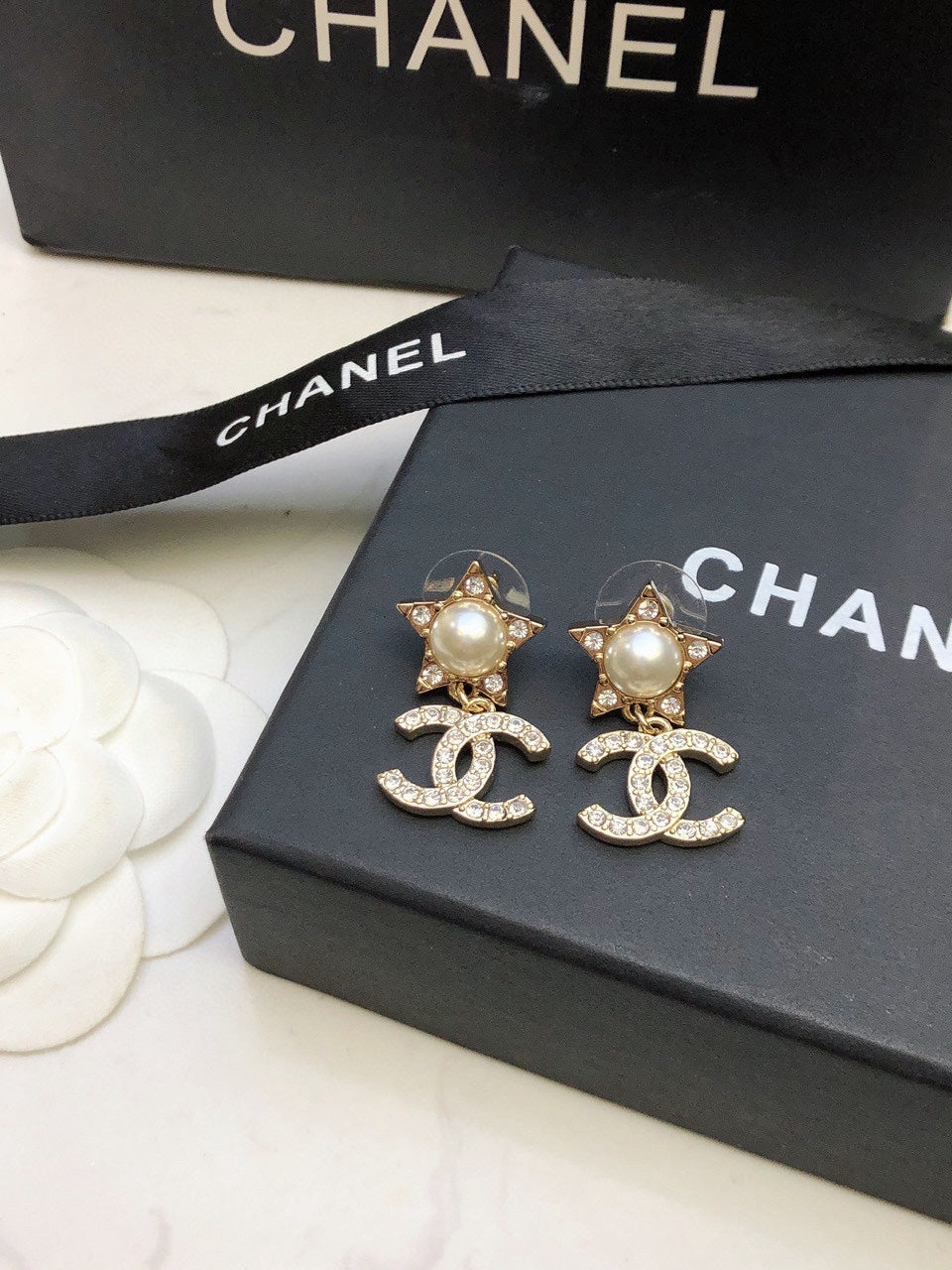 Martin Graham stud earrings in polished metal-tone – close-up detail