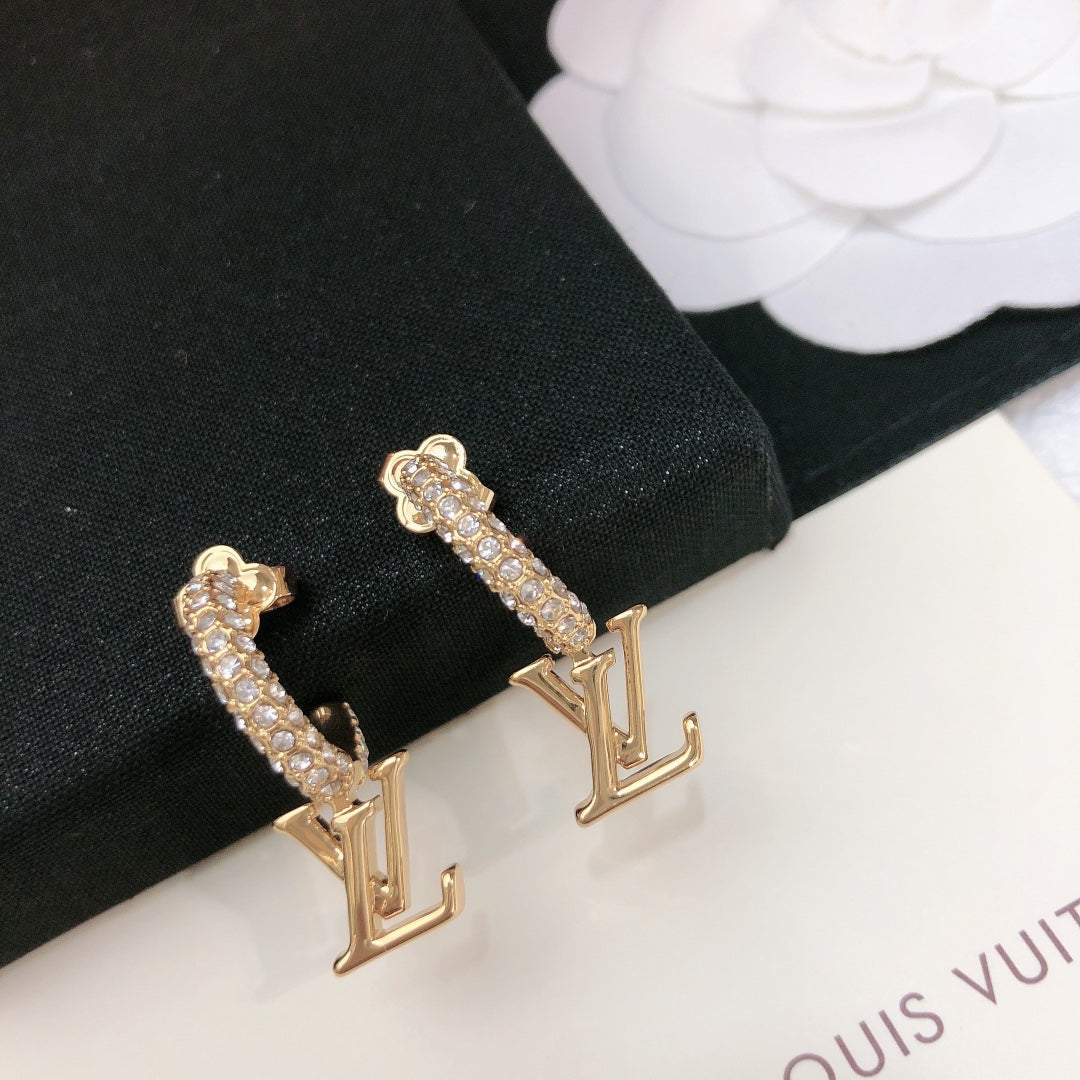 Martin Graham stud earrings in polished metal-tone – close-up detail