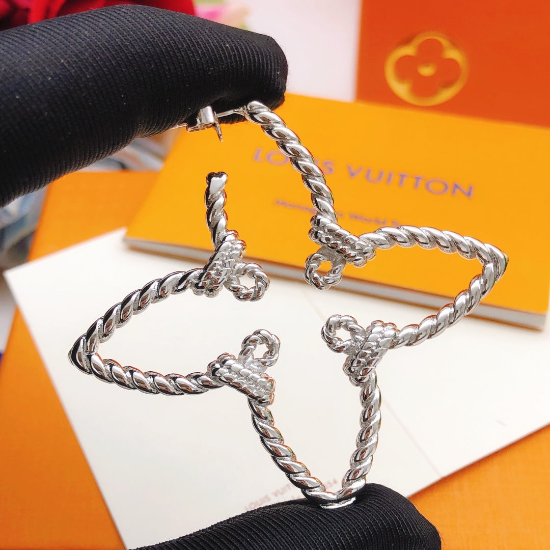 Martin Graham stud earrings in polished metal-tone – close-up detail