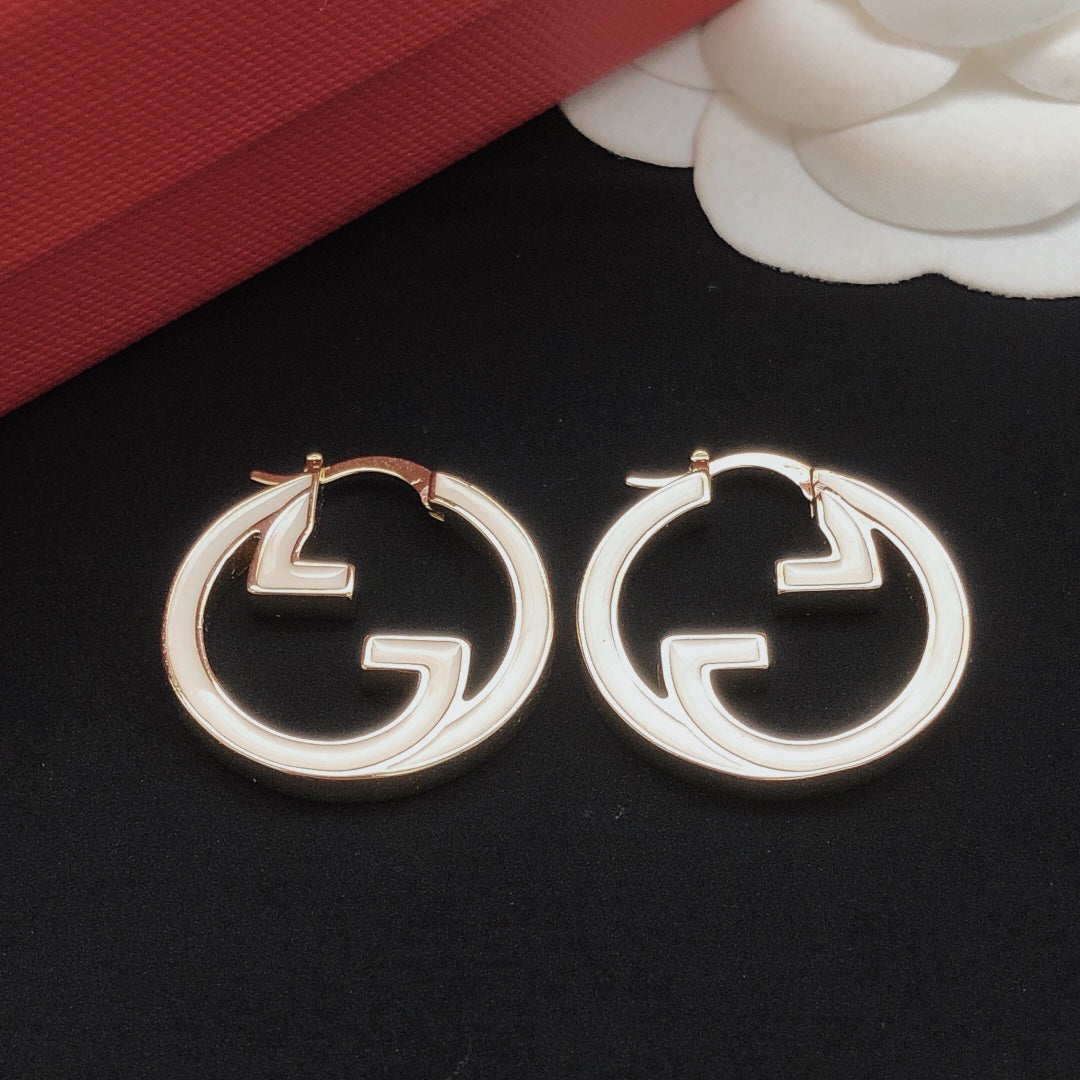 Martin Graham earrings in polished metal-tone – close-up detail