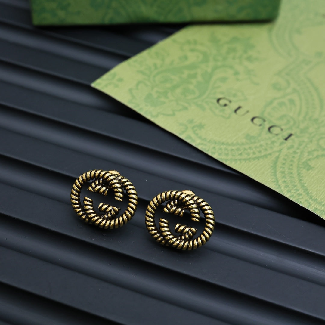Martin Graham stud earrings in polished metal-tone – front product view