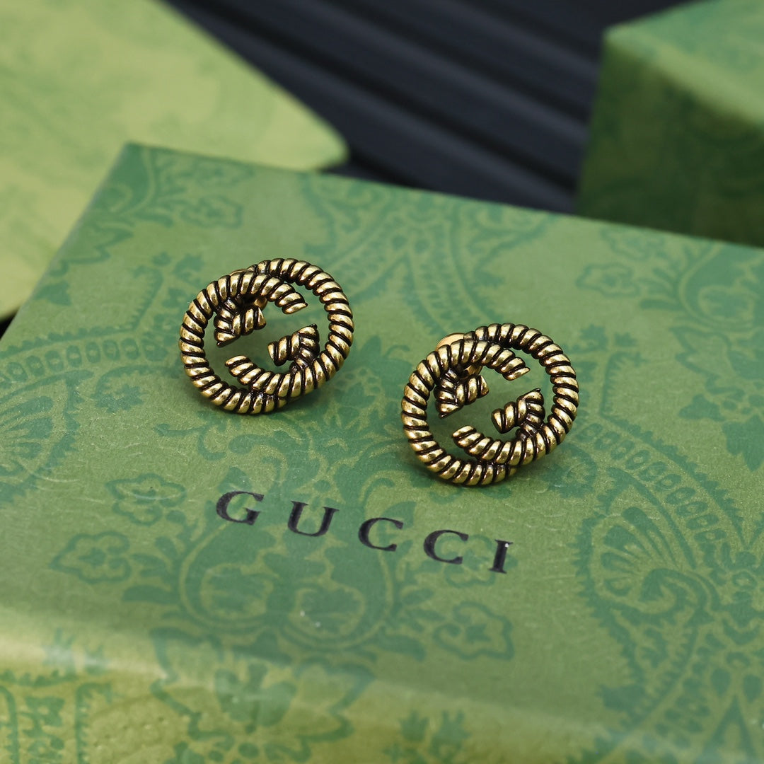 Martin Graham stud earrings in polished metal-tone – detail view