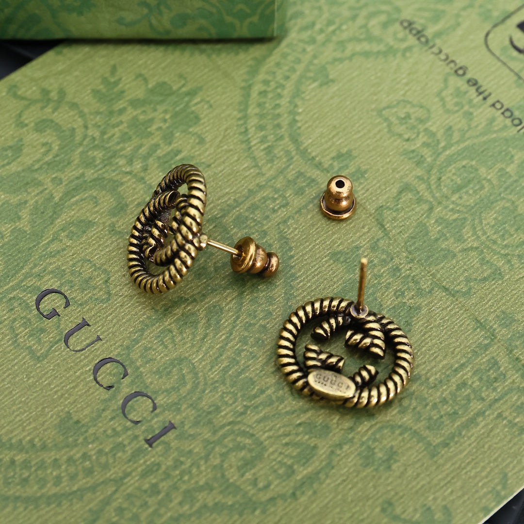 Martin Graham stud earrings in polished metal-tone – close-up detail