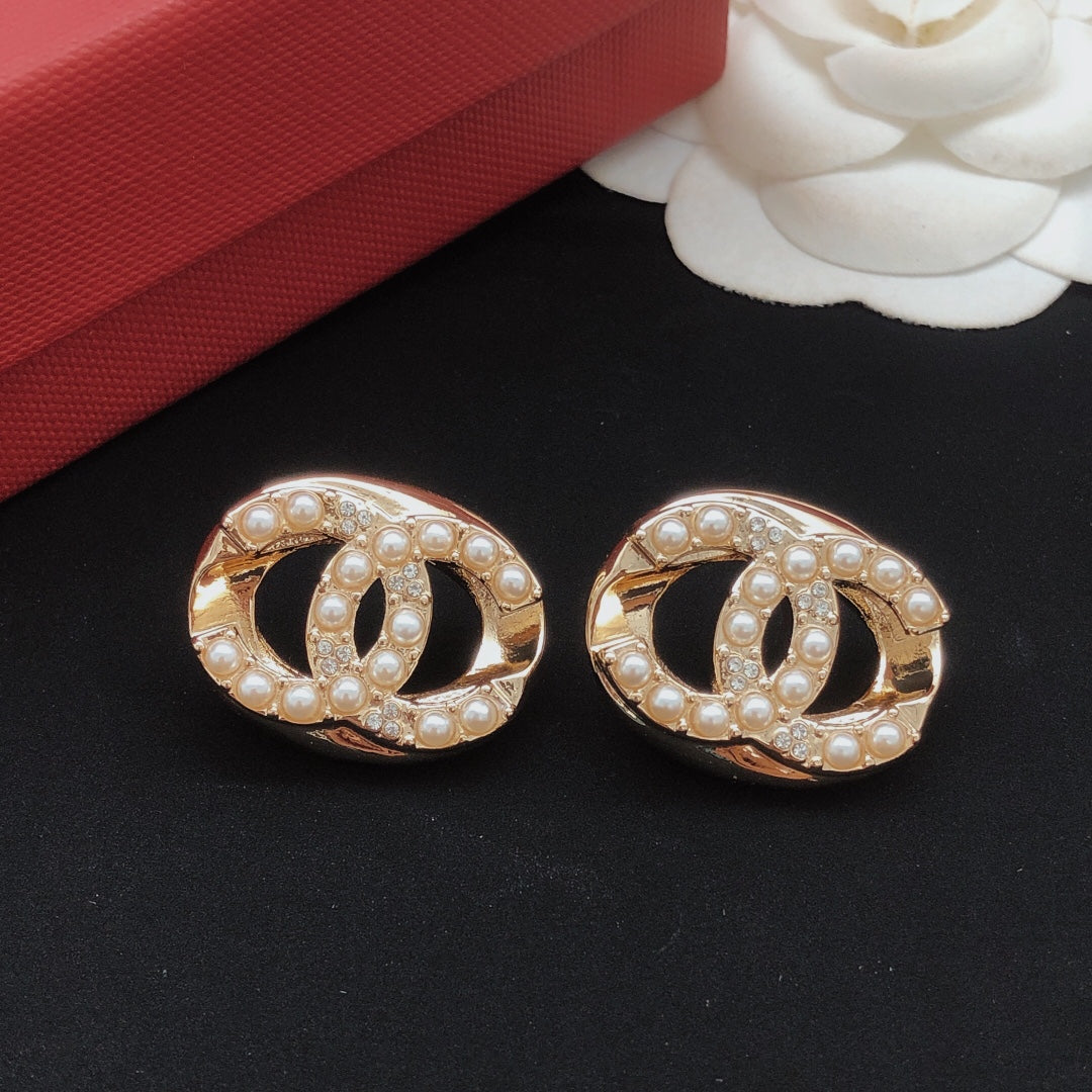 Martin Graham stud earrings in polished metal-tone – styled product view