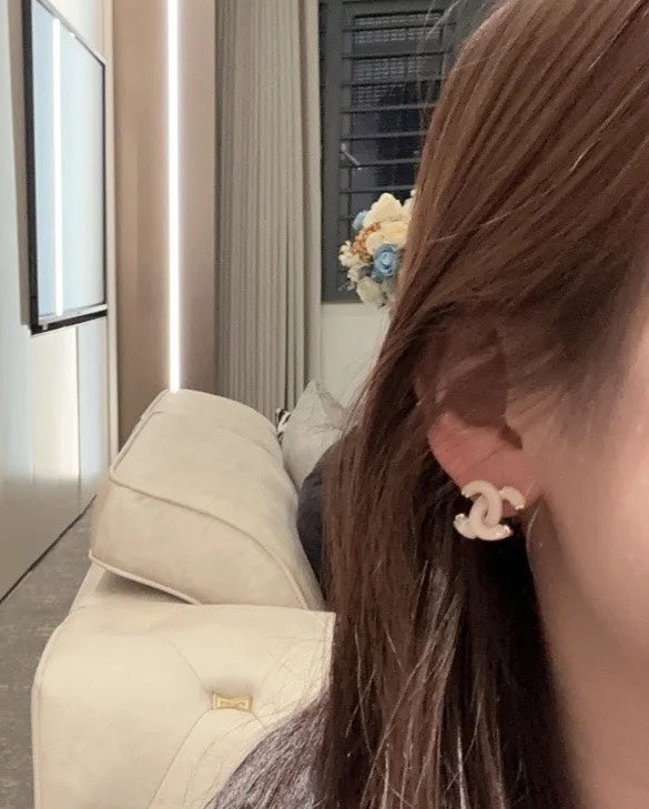 Martin Graham stud earrings in polished metal-tone – front product view