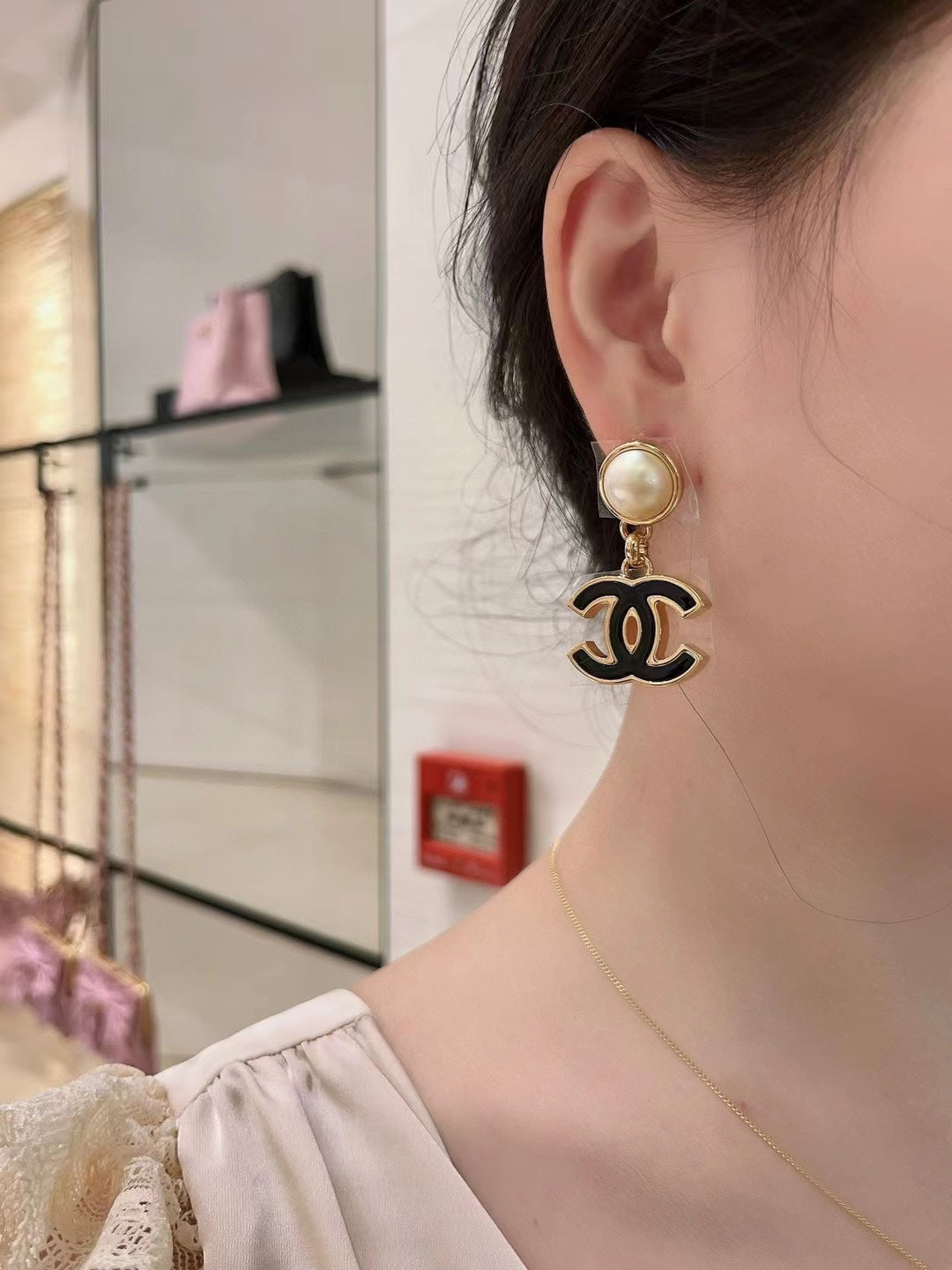 Martin Graham stud earrings in polished metal-tone – close-up detail