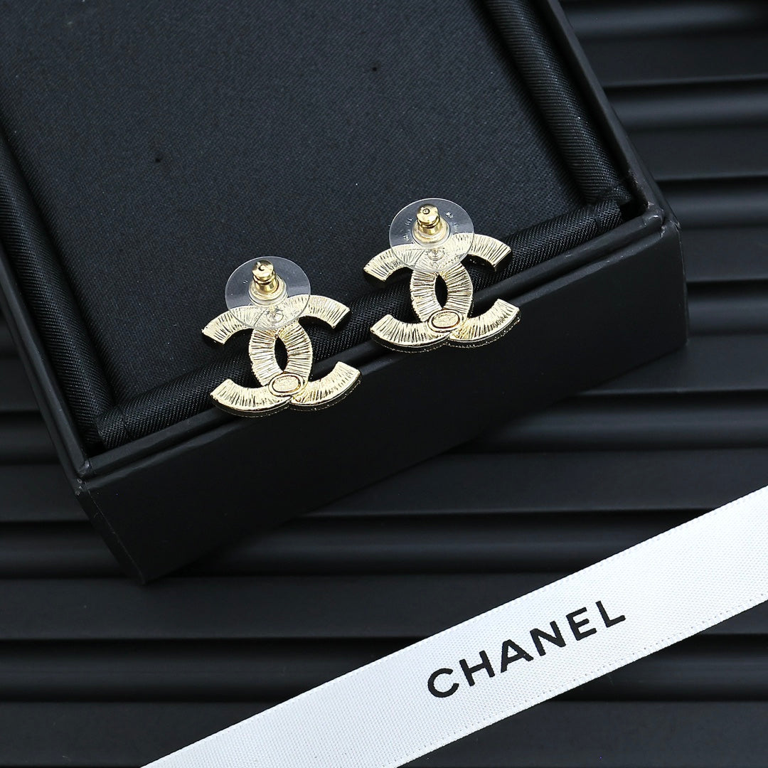 Martin Graham stud earrings in polished metal-tone – detail view