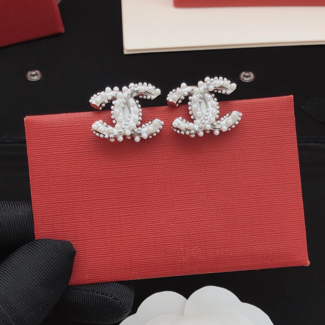 Martin Graham stud earrings in polished metal-tone – front product view