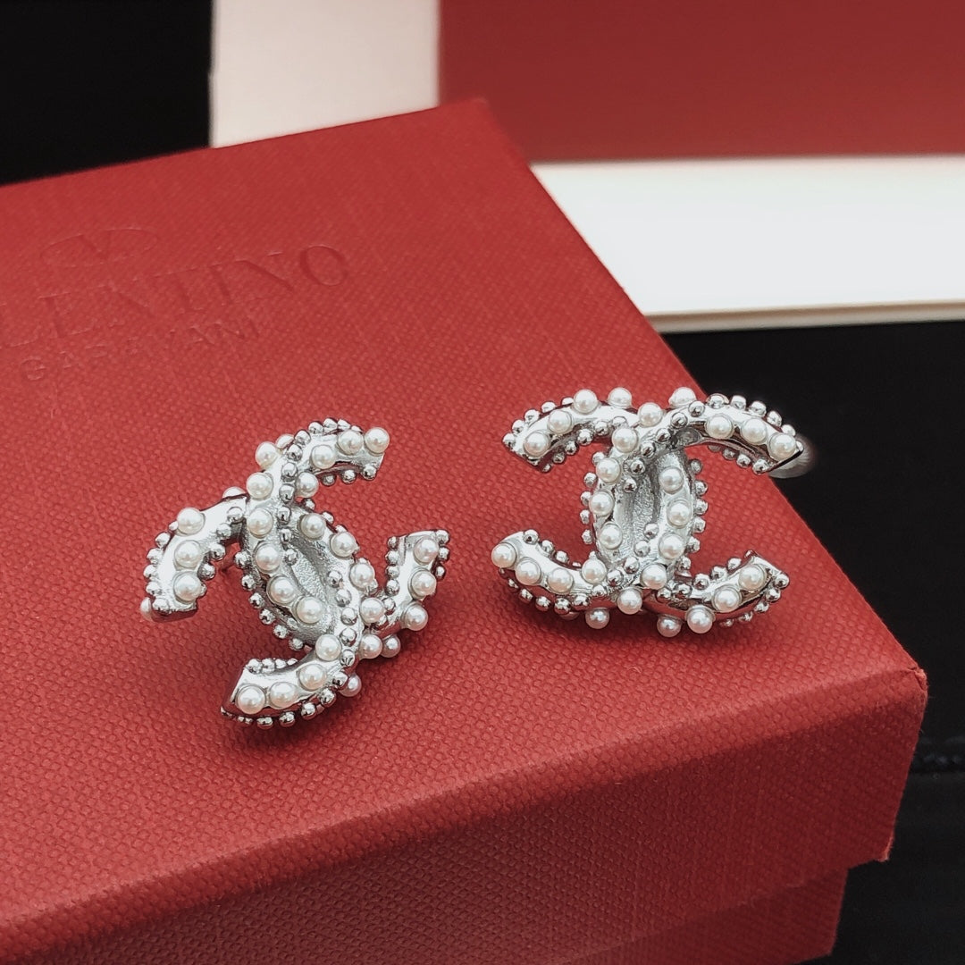 Martin Graham stud earrings in polished metal-tone – close-up detail