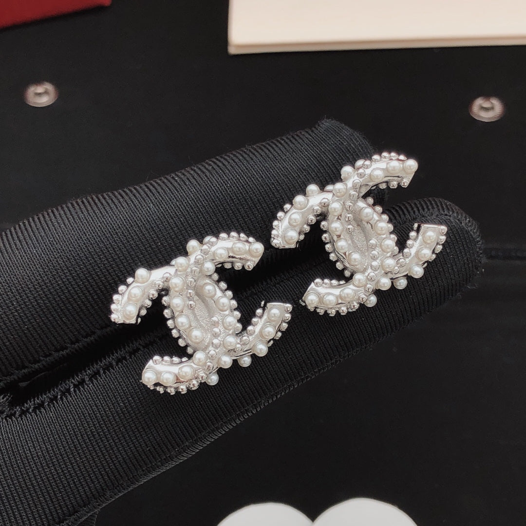 Martin Graham stud earrings in polished metal-tone – front product view