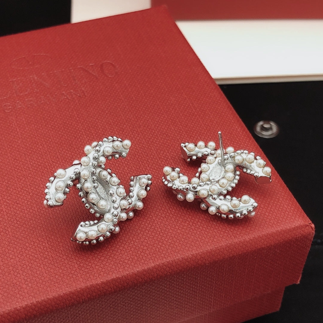 Martin Graham stud earrings in polished metal-tone – styled product view