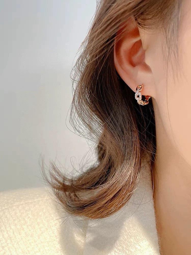 Martin Graham stud earrings in polished metal-tone – detail view