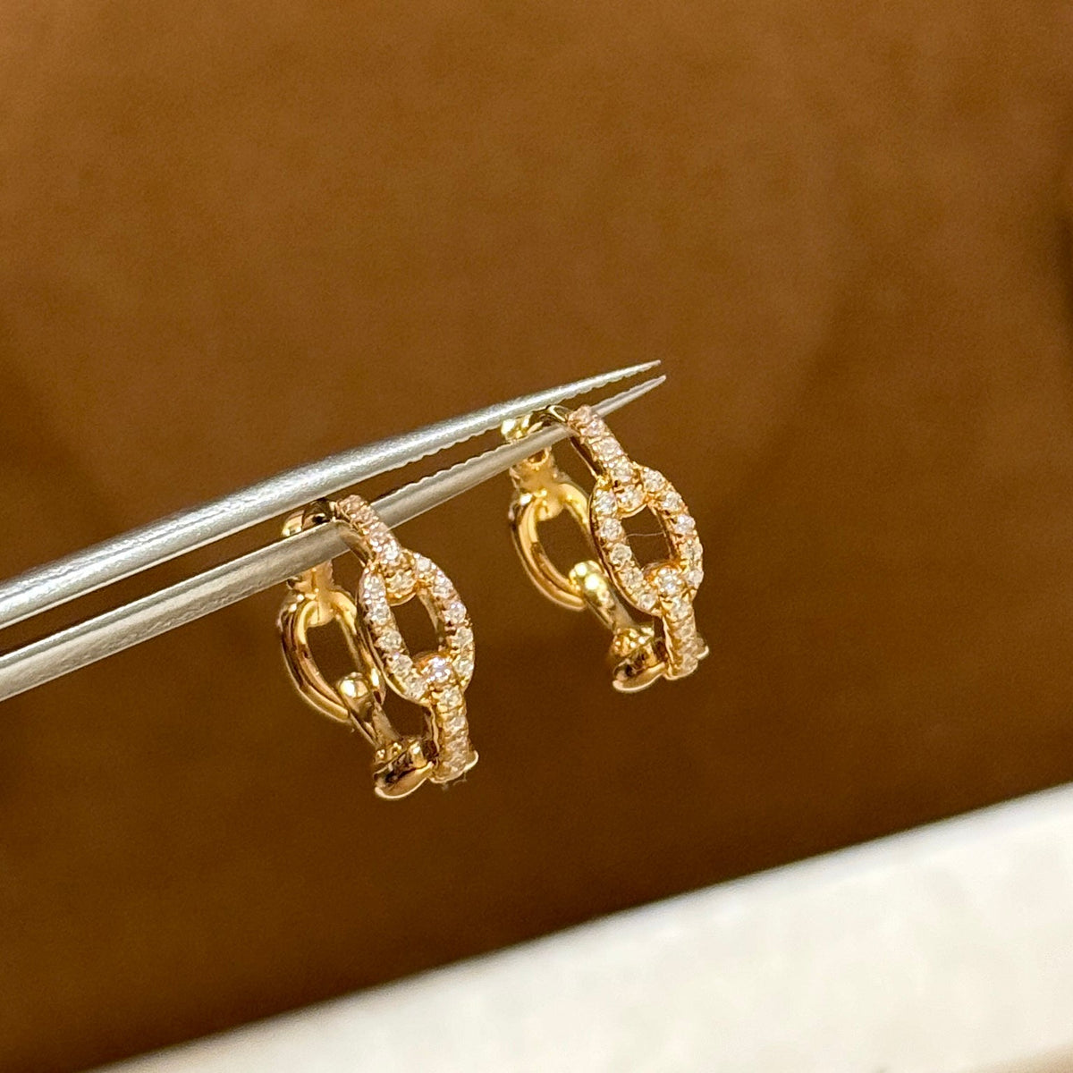 Martin Graham stud earrings in polished metal-tone – close-up detail