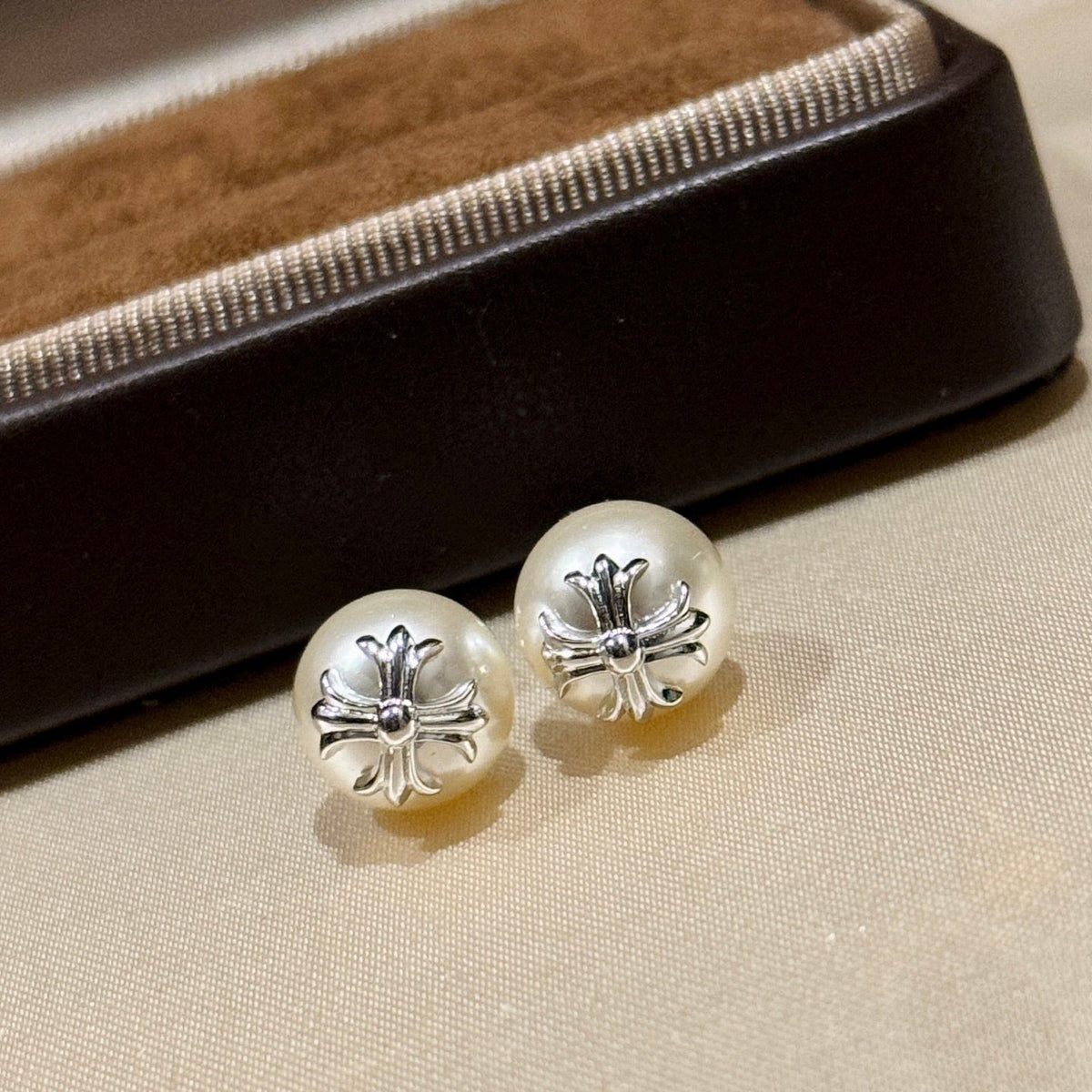 Martin Graham stud earrings in polished metal-tone – detail view