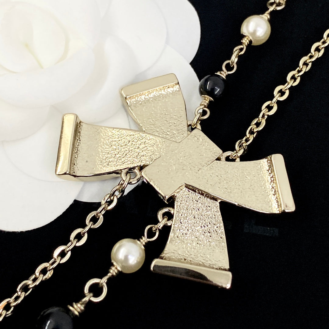 Martin Graham pendant necklace in polished metal-tone – close-up detail