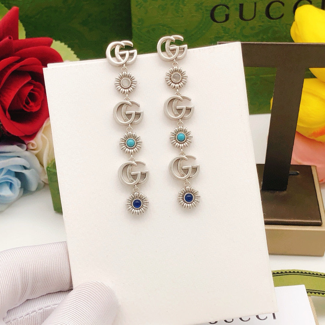 Martin Graham stud earrings in polished metal-tone – detail view