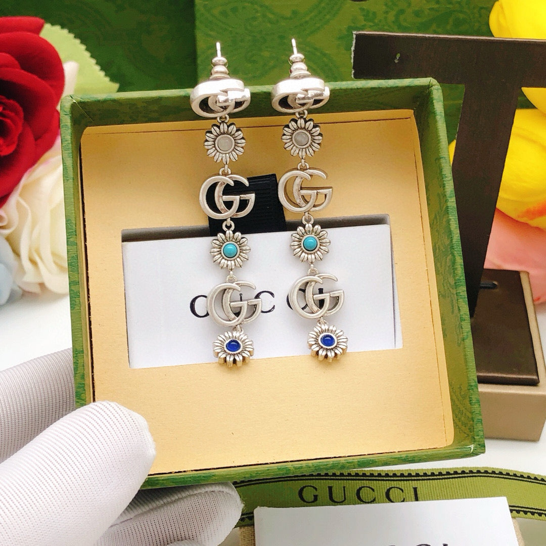 Martin Graham stud earrings in polished metal-tone – styled product view