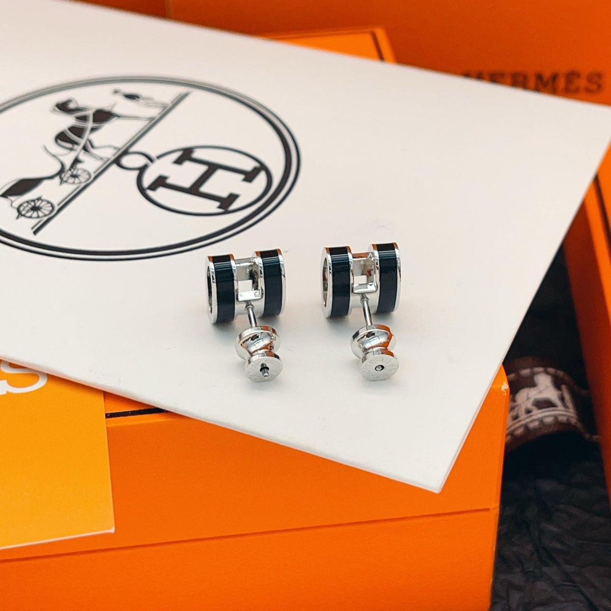 Martin Graham stud earrings in polished metal-tone – detail view