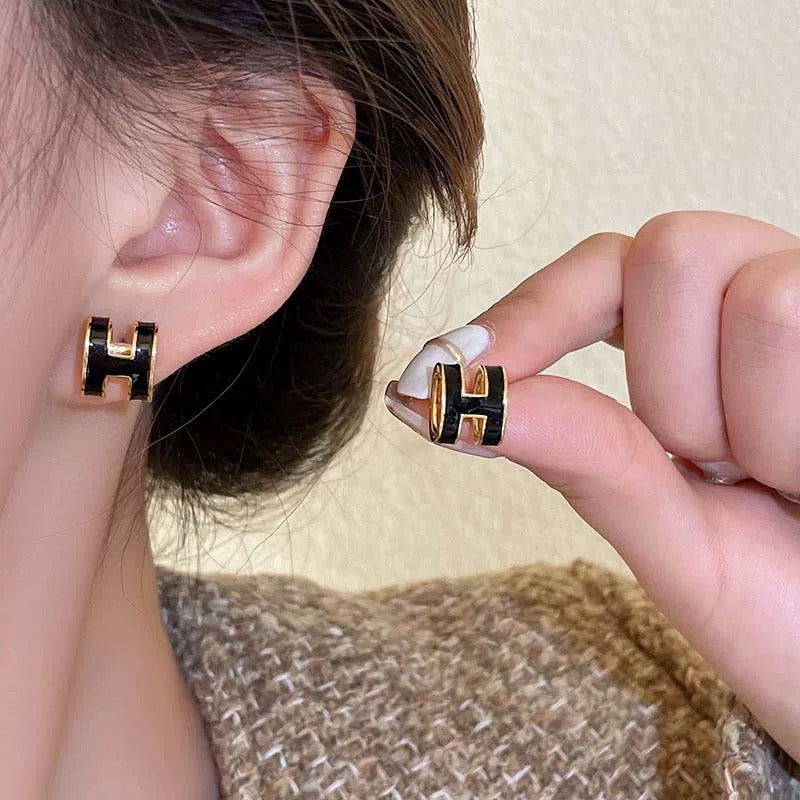 Martin Graham stud earrings in polished metal-tone – front product view