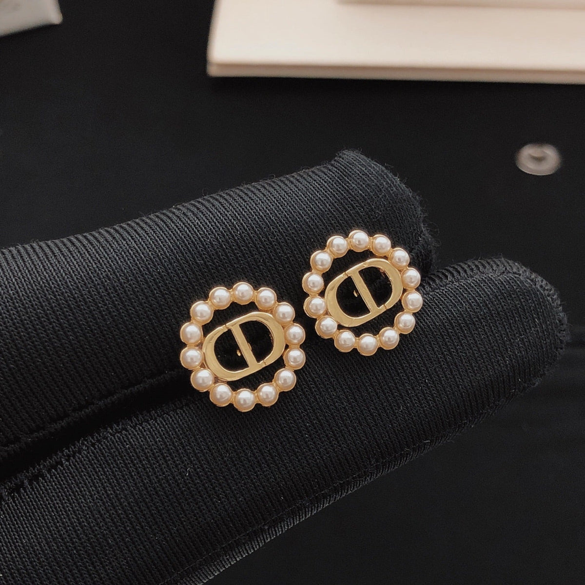 Martin Graham stud earrings in polished metal-tone – detail view