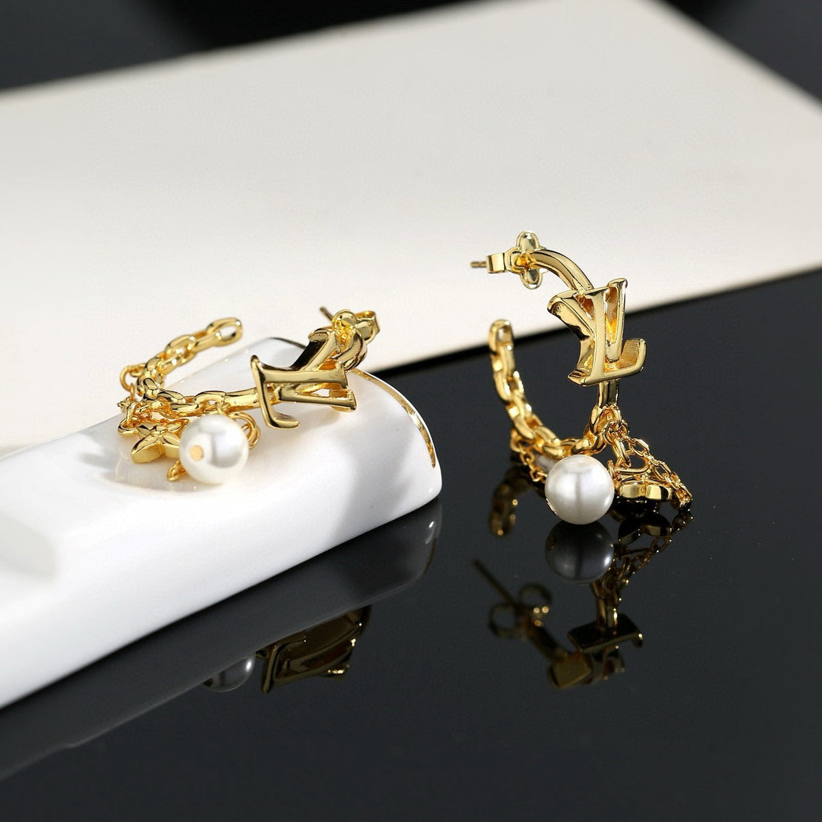 Martin Graham stud earrings in polished metal-tone – side detail